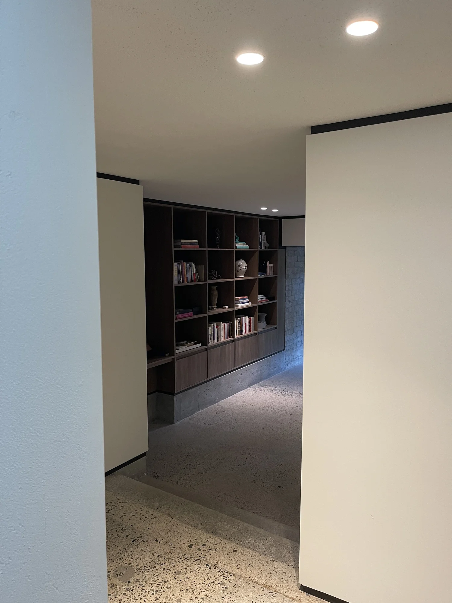 Terrazzo hall with built-in walnut library