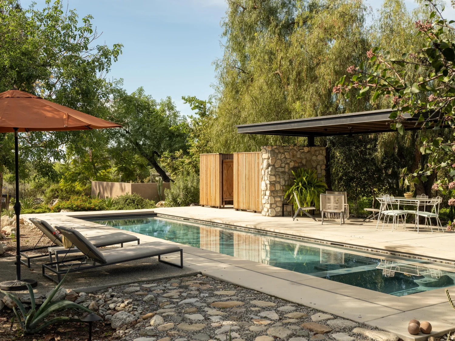 Lap pool and stone-clad pool pavilion