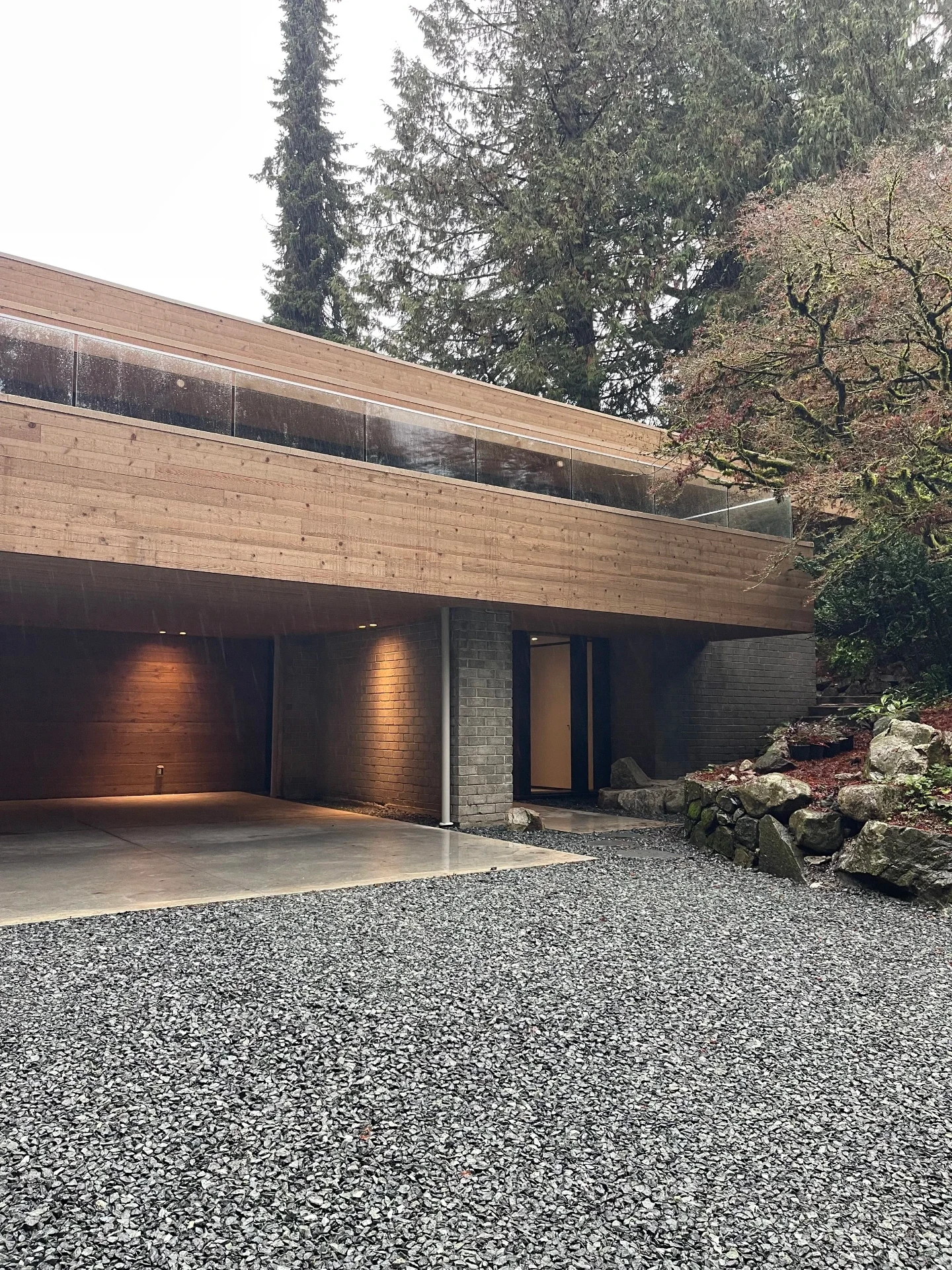 Carport under the cedar-clad volume