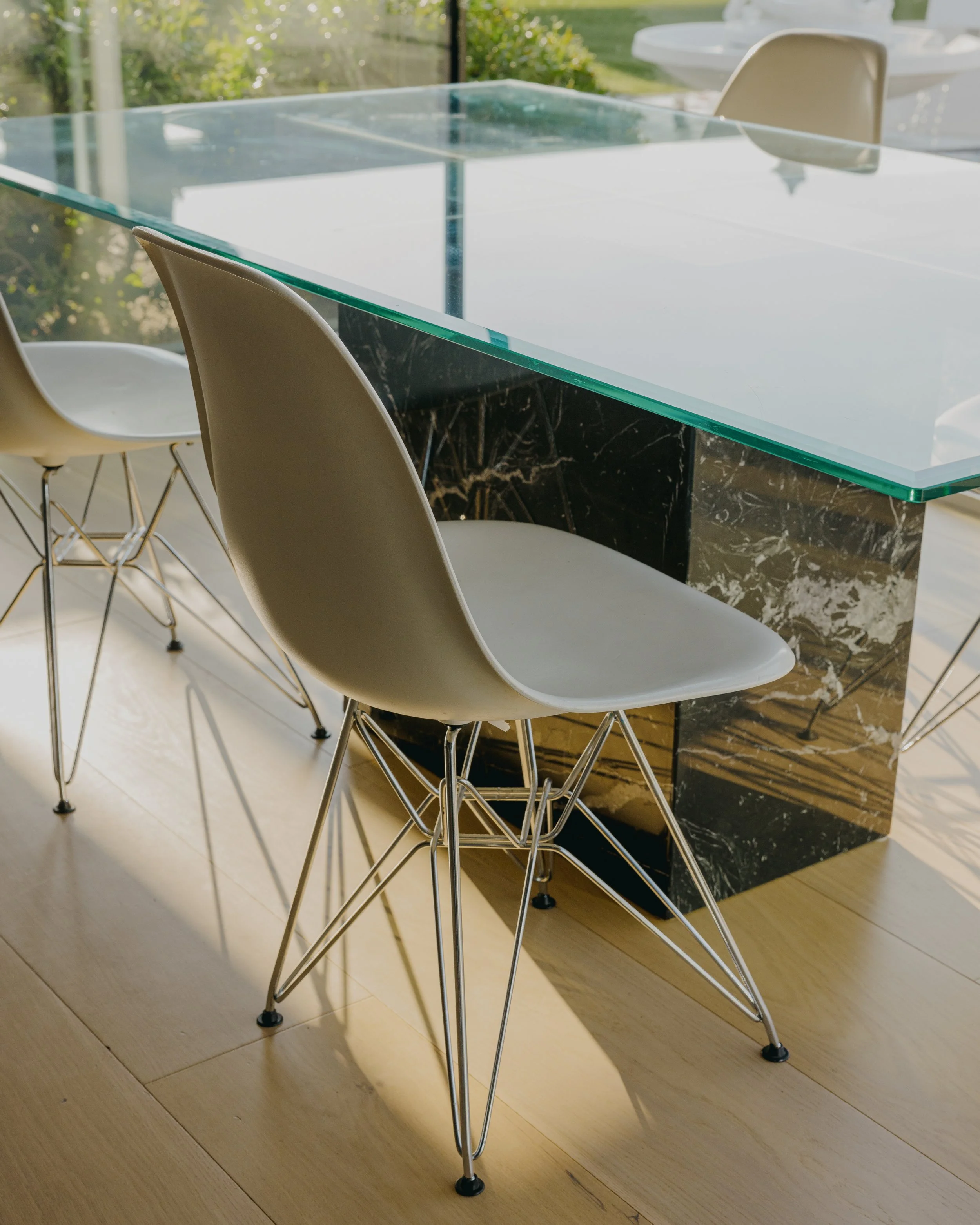 Glass dining table beside the pool terrace